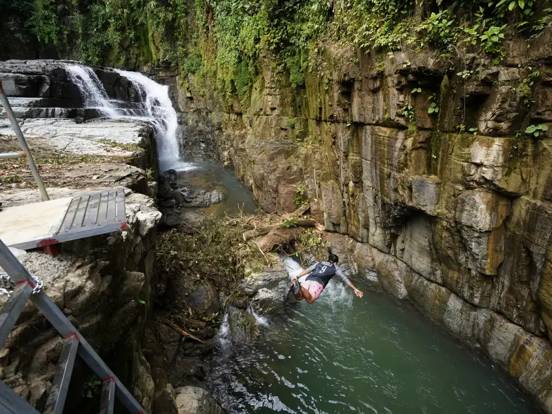 hrilling cliff jumping into the pool at Eco Chontales Waterfall, Costa Rica.