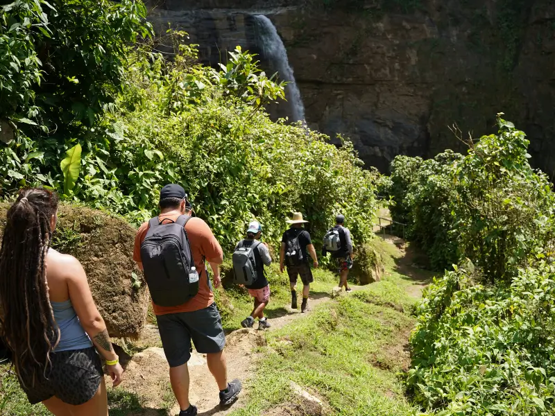 A family enjoying the waterfall pools and natural rock slides at Eco Chontales